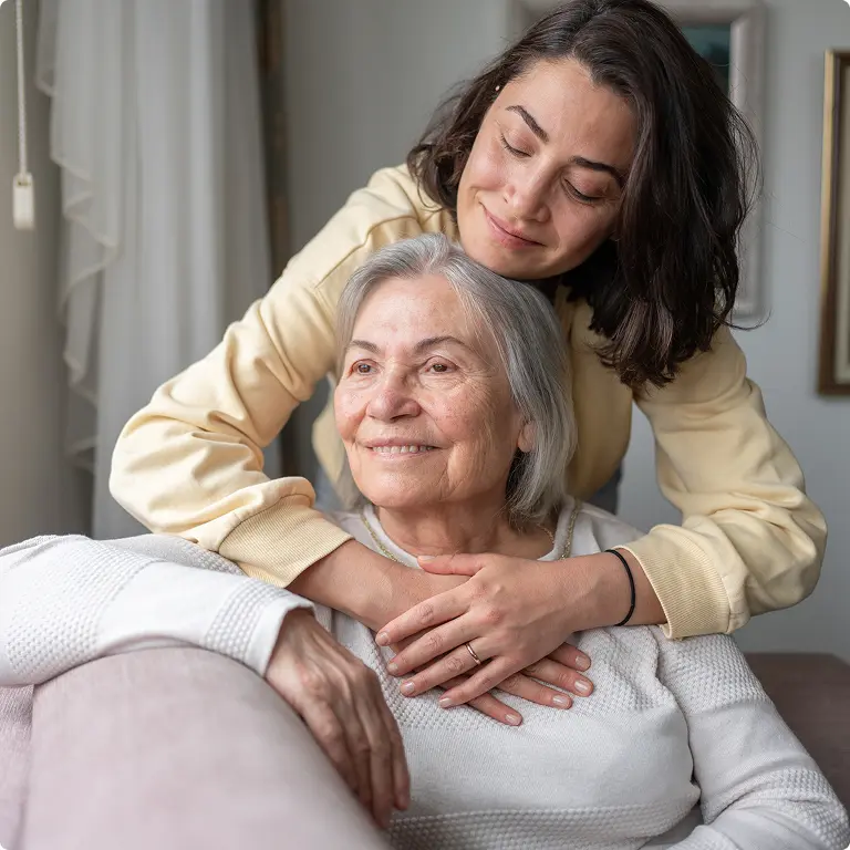 Younger woman hugging an elderly woman, conveying care; concept image for dementia diagnostics and Smart Minds Dx blood test